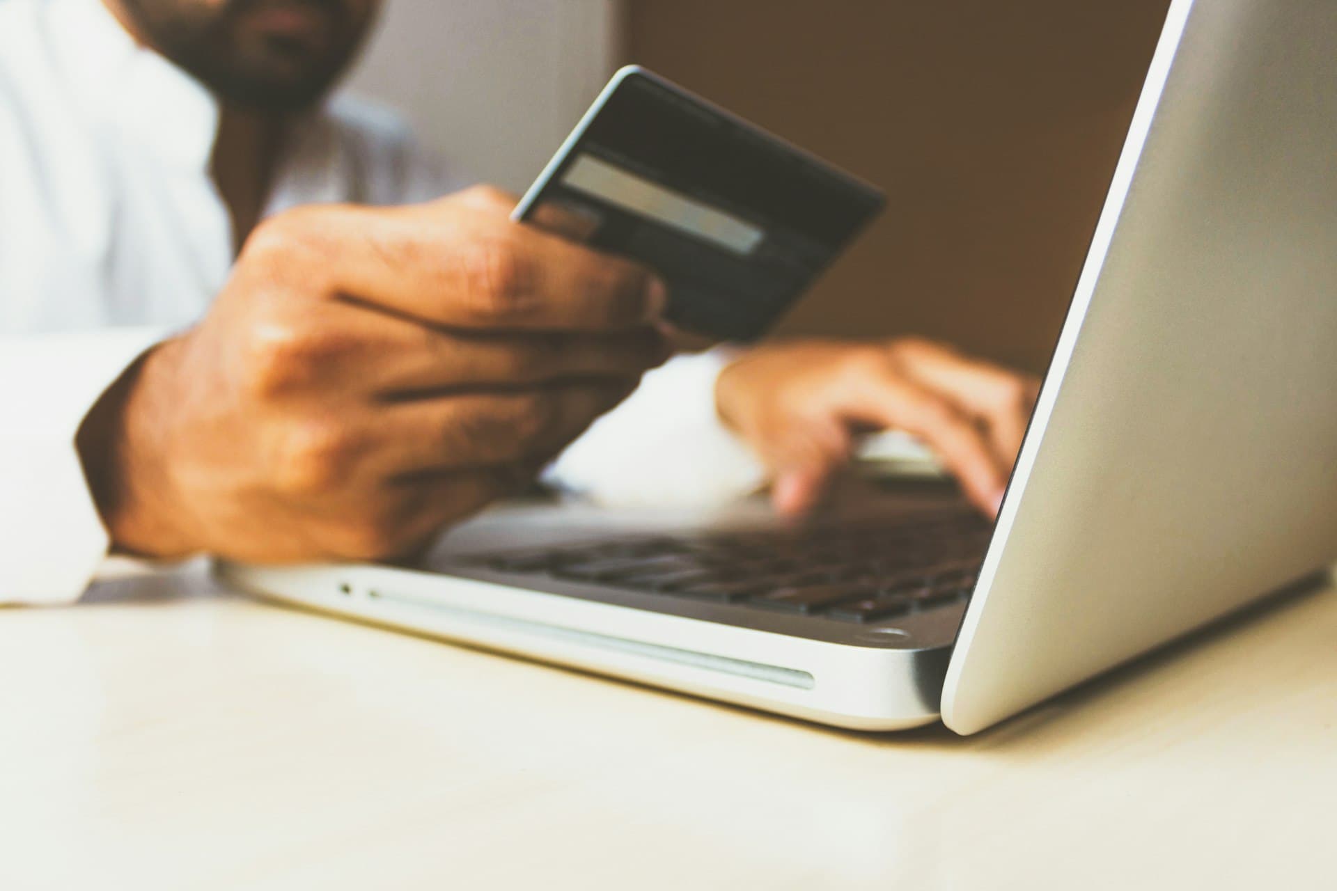 Online checkout with a payment card at a laptop
