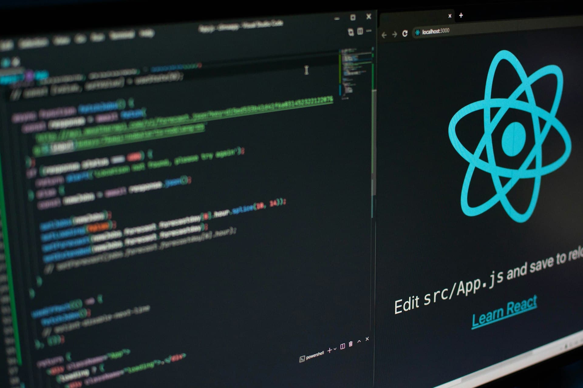 React code and logo on developer monitors